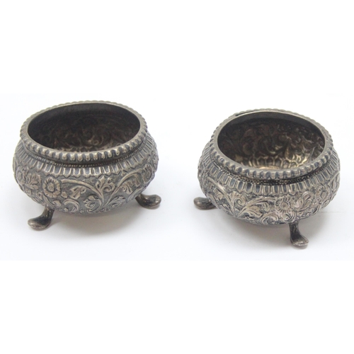 1016 - A pair of Indian embossed silver salts, unmarked but XRF tests approx 91% silver, approx 77.63g gros... 