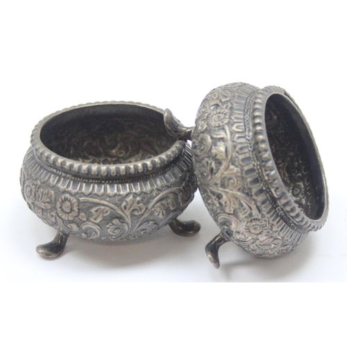 1016 - A pair of Indian embossed silver salts, unmarked but XRF tests approx 91% silver, approx 77.63g gros... 