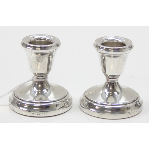 1038 - A pair of dwarf silver candlesticks, each approx 5.5cm tall, Birmingham 1979 by Laurence R Watson & ... 