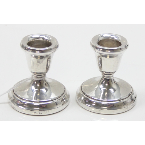 1038 - A pair of dwarf silver candlesticks, each approx 5.5cm tall, Birmingham 1979 by Laurence R Watson & ... 