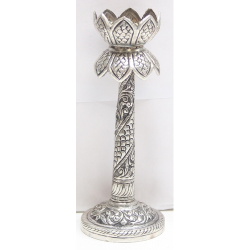 1057 - A small interesting silver pricket style candlestick with embossed decoration, marked silver and XRF... 