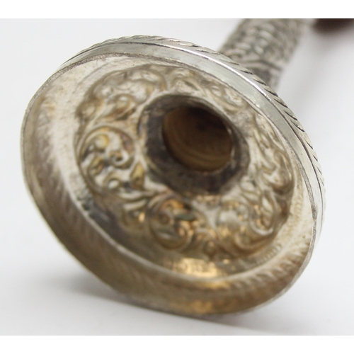 1057 - A small interesting silver pricket style candlestick with embossed decoration, marked silver and XRF... 