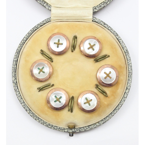 1121 - A cased set of gilt metal shirt studs formed as buttons, early 20th century