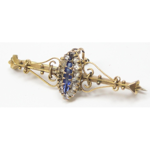 1125 - A late 19th or early 20th century 9ct gold bar brooch set with central blue stone surrounded by whit... 