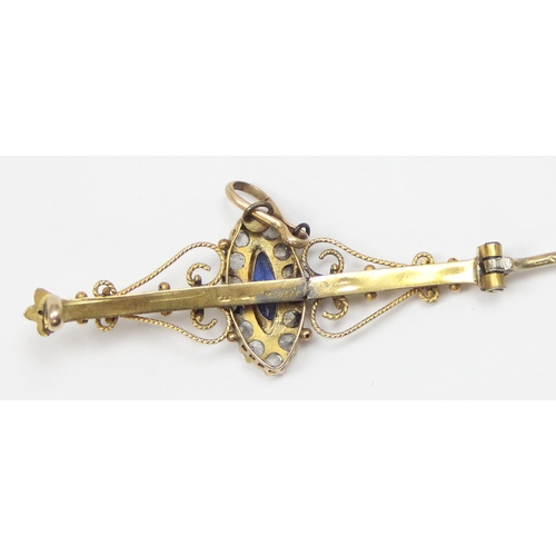 1125 - A late 19th or early 20th century 9ct gold bar brooch set with central blue stone surrounded by whit... 