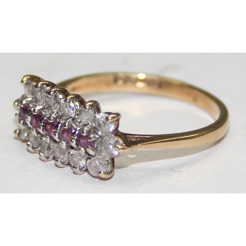 1129 - A 9ct yellow gold ring set with rubies and white stones, approx size L 1/2, approx 2.25g gross