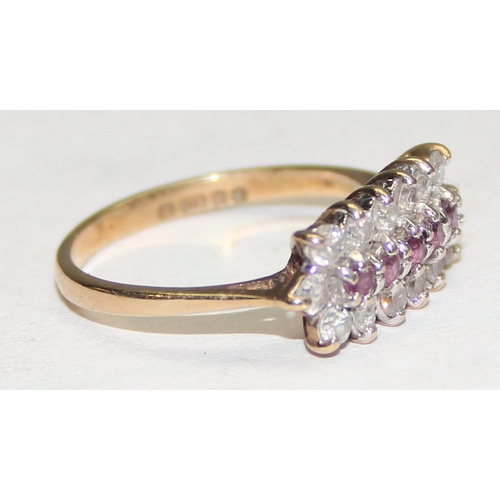 1129 - A 9ct yellow gold ring set with rubies and white stones, approx size L 1/2, approx 2.25g gross