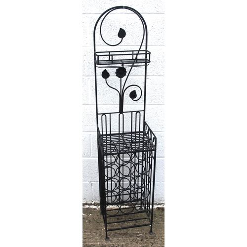 149 - Wrought iron 15 bottle utility wine rack, 2 wrought iron stools and a wrought iron candle holder