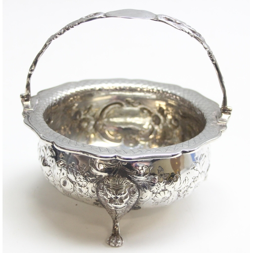 1046 - A George IV period silver basket with swing handle, embossed floral decoration with 3 lion mask and ... 