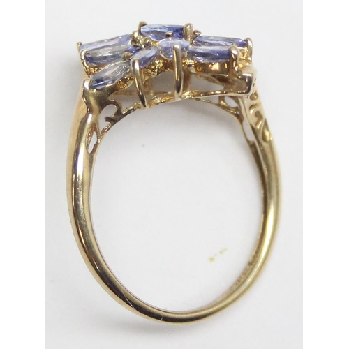 1135 - A 9ct gold ring set with light blue or purple stones in floral setting, marked 9k and XRF confirmed,... 