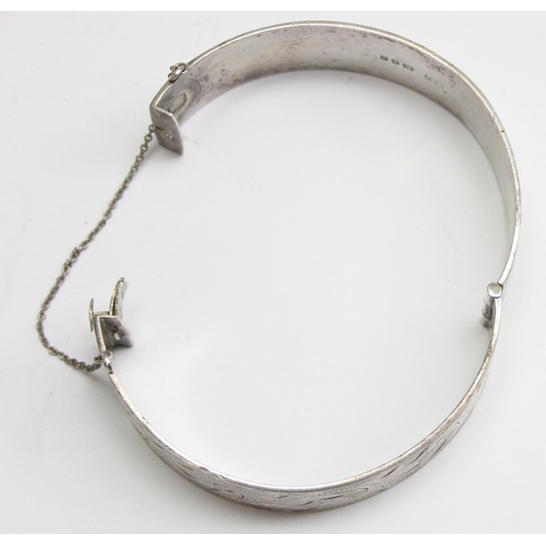 1136 - A vintage silver cuff bangle with engraved decoration, London 1974, approx 65mm in diameter, approx ... 