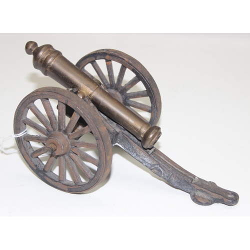 1650 - A miniature vintage brass and iron model of a canon on wheels, approx 20cm wide