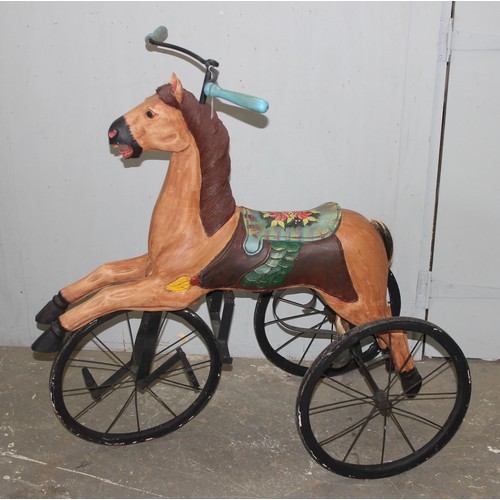 1500 - An antique style Indonesian velocipede horse formed tricycle, the horse formed from carved and paint... 