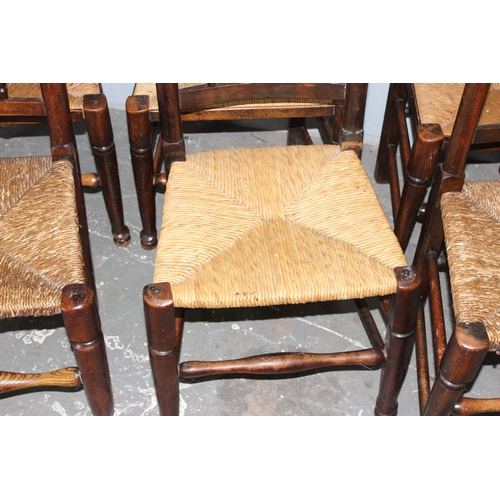 146 - A matched set of 8 Arts & Crafts period oak spindle back dining chairs with rush seats