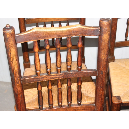 146 - A matched set of 8 Arts & Crafts period oak spindle back dining chairs with rush seats