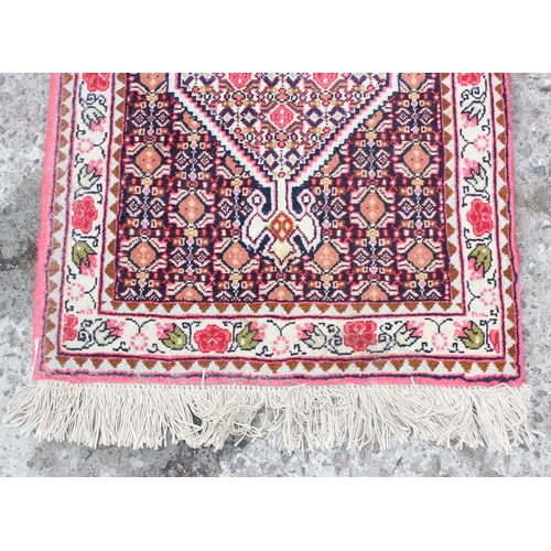 215 - A fine quality Persian Sanandaj runner rug of red and darker ground, fine knot structure, approx 54c... 