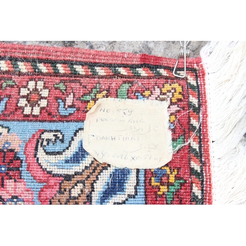 217 - A vintage Persian Bakhtiar rug of red and cream ground, approx 98cm x 53cm