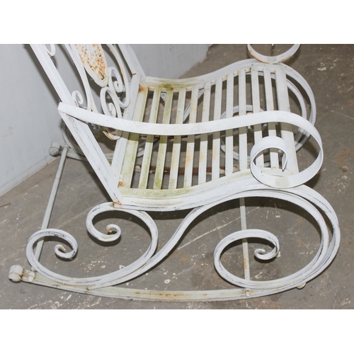 328 - A Victorian style wrought iron garden rocking chair, approx 65cm W x 94cm D x 91cm H