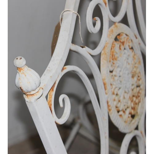 328 - A Victorian style wrought iron garden rocking chair, approx 65cm W x 94cm D x 91cm H