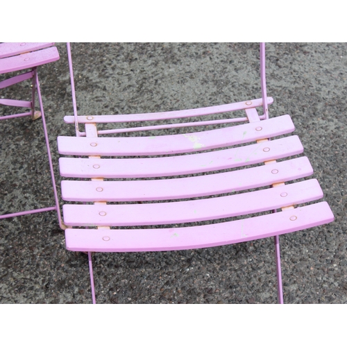 329 - A pink folding metal garden bistro table and 4 chairs