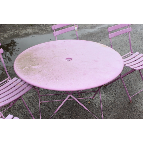 329 - A pink folding metal garden bistro table and 4 chairs