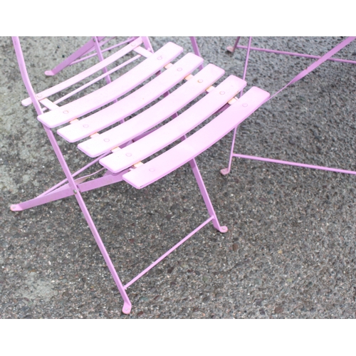 329 - A pink folding metal garden bistro table and 4 chairs