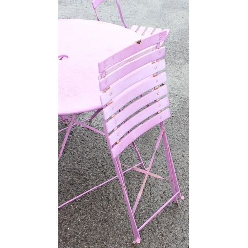 329 - A pink folding metal garden bistro table and 4 chairs