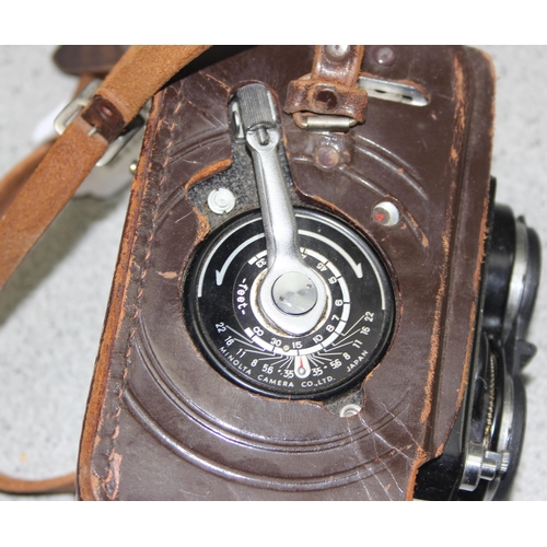 657 - A vintage Minolta Autocord TLR camera in leather case