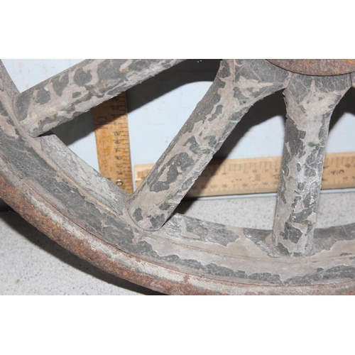 712 - A pair of vintage wooden and iron rimmed early car wheels, unknown vehicle, approx 60cm in diameter