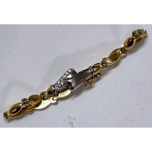 1119 - A 14ct white and yellow gold bracelet set with small white stones, marked 585 and XRF confirmed, app... 