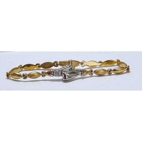 1119 - A 14ct white and yellow gold bracelet set with small white stones, marked 585 and XRF confirmed, app... 