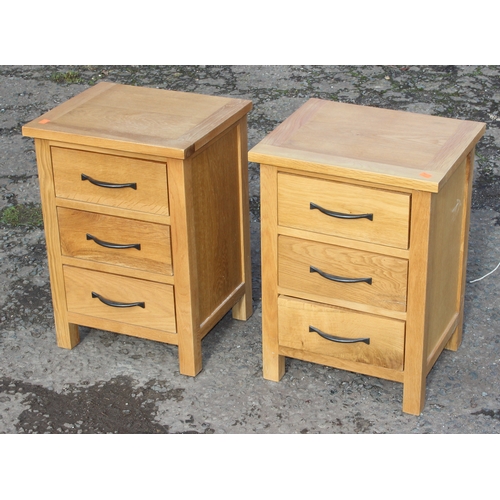 15 - Pair of light oak 3-drawer bedside tables with iron handles, approx 42cm W x 35cm D x 58cm H