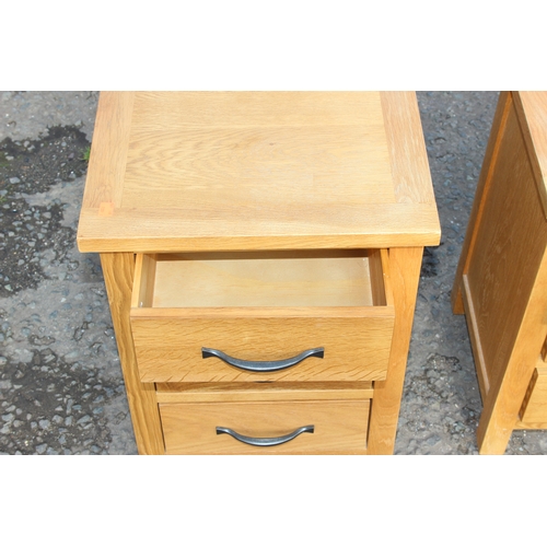 15 - Pair of light oak 3-drawer bedside tables with iron handles, approx 42cm W x 35cm D x 58cm H