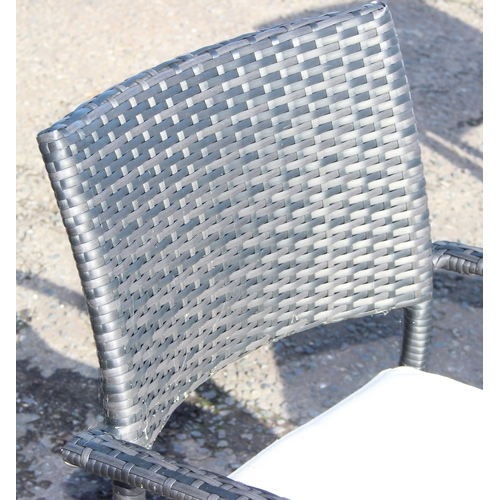 300 - Rattan garden seat set comprising 2 arm chairs and glass-topped cube table (50cm x 50cm x 45cm)