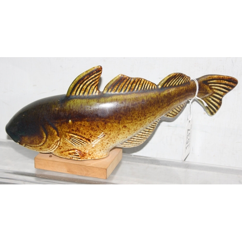 1637 - Sven Wejsfelt for Gustavberg, a ceramic fish on a wooden stand, the stand with printed makers marks,... 