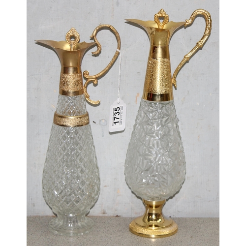 1735 - Matched pair of pressed crystal glass decanters/claret jugs with gold tone detail, largest approx 39... 