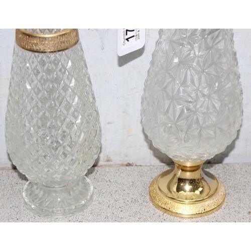 1735 - Matched pair of pressed crystal glass decanters/claret jugs with gold tone detail, largest approx 39... 