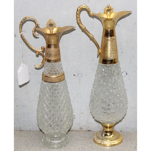 1735 - Matched pair of pressed crystal glass decanters/claret jugs with gold tone detail, largest approx 39... 