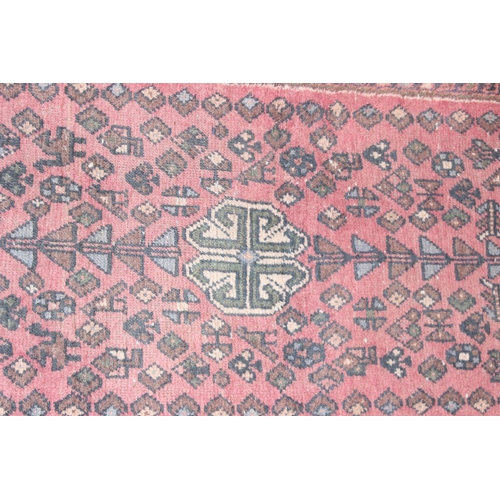 204 - A vintage Persian red ground rug, possibly Senneh, likely early 20th century, approx 180cm x 73cm