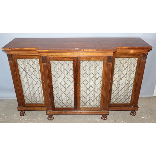 70 - A Regency period rosewood sideboard with lion paw feet and pierced brass grills with curtain backs, ... 