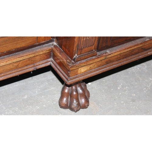 70 - A Regency period rosewood sideboard with lion paw feet and pierced brass grills with curtain backs, ... 