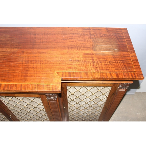 70 - A Regency period rosewood sideboard with lion paw feet and pierced brass grills with curtain backs, ... 