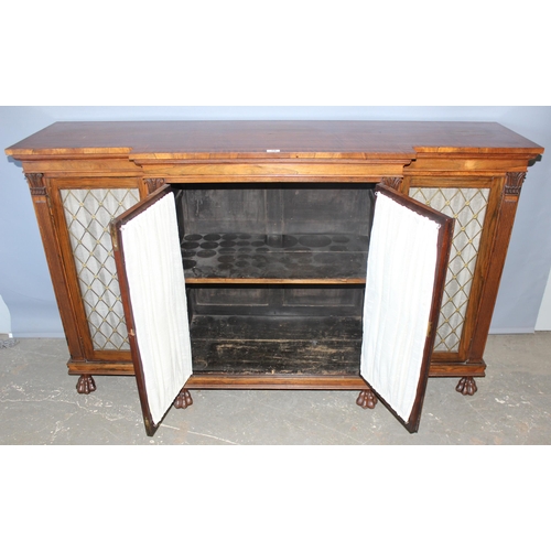 70 - A Regency period rosewood sideboard with lion paw feet and pierced brass grills with curtain backs, ... 