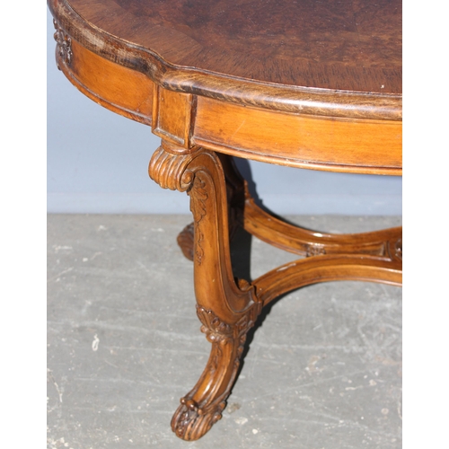 73 - A good quality 20th century walnut coffee table with carved base and legs, approx 114cm wide x 50cm ... 