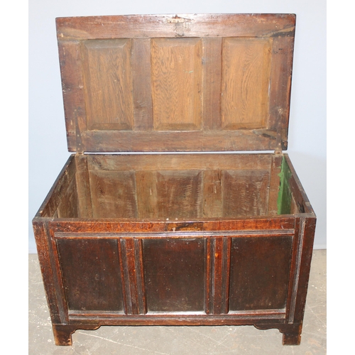 75 - An antique panelled oak coffer, likely 18th century, approx 100cm wide x 74cm deep x 70cm tall