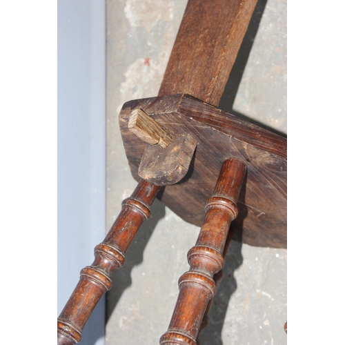 77 - A vintage Welsh oak or elm spinning chair on turned wooden legs