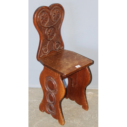 78 - An unusual Arts & Crafts period carved oak hall chair, approx 94cm tall