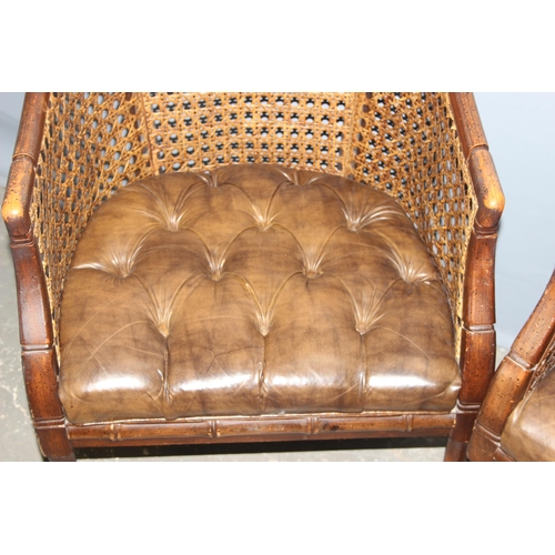 84 - In the manner of John Widdicomb, a pair of bergere and button seated tub chairs with faux bamboo eff... 