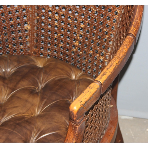 84 - In the manner of John Widdicomb, a pair of bergere and button seated tub chairs with faux bamboo eff... 