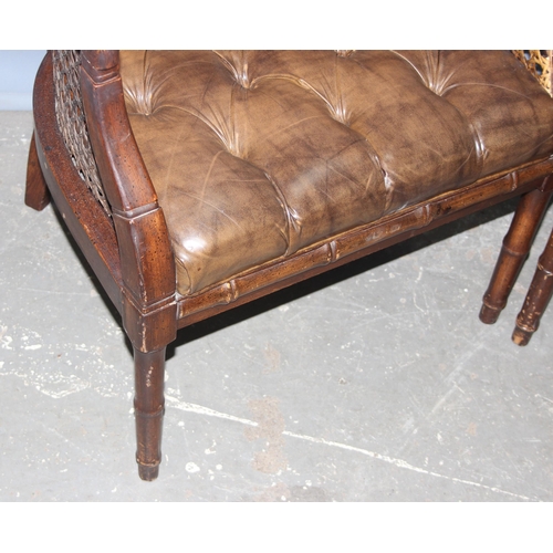 84 - In the manner of John Widdicomb, a pair of bergere and button seated tub chairs with faux bamboo eff... 